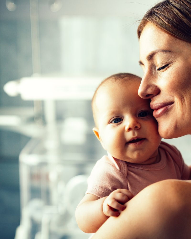 A mother holding her newborn baby