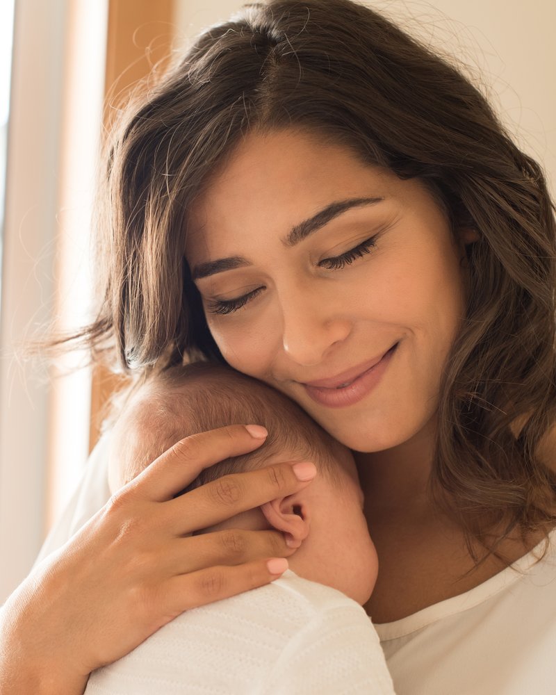 A mother holding her newborn baby